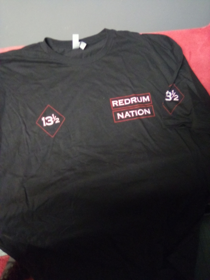 May include: Black long-sleeve t-shirt with red text that reads "Redrum Nation" and two red diamond shapes with the text "13 1/2" and "3 1/2".