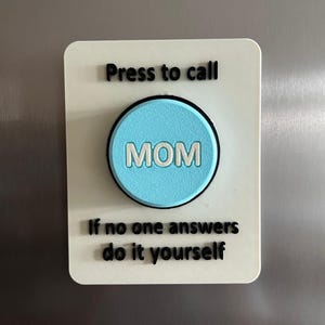 May include: A rectangular white magnet with rounded corners. It features the text "Press to call" above a light blue circle with the word "MOM" in white. Below, it reads "If no one answers do it yourself."