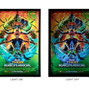 May include: A movie poster for the film "Thor: Ragnarok" featuring Thor, Hulk, Hela, and Loki. The poster has a colorful, abstract design with a green, orange, and blue color scheme. The text "Thor: Ragnarok" is in large, white letters at the bottom of the poster.