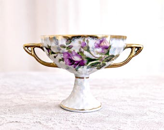 Copa de pedestal Royal Sealy de mediados de siglo con rosas moradas y ribete dorado, fabricada en Japón.