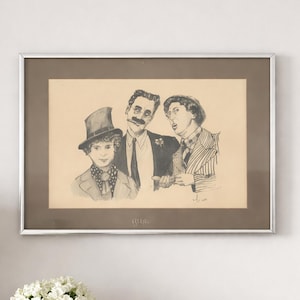 May include: A framed pencil sketch of three men in formal attire. The central figure has a large mustache and is wearing a suit. The other two men are wearing hats and patterned jackets. The artwork is in a silver frame.