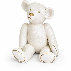 May include: A white ceramic mug with a black handle and the text "But First, Coffee" in a handwritten style. The mug is on a white surface. The mug is 10 cm tall.