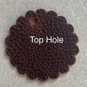 Leather rosette with top hole punched.