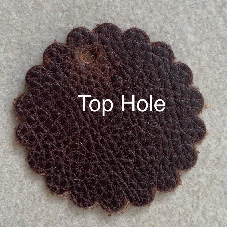 Leather rosette with top hole punched.