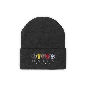 May include: A dark grey beanie with a black and white logo that says "UNITY WEAR" and features five fists in a circle, each fist a different color: yellow, red, brown, white, and black.