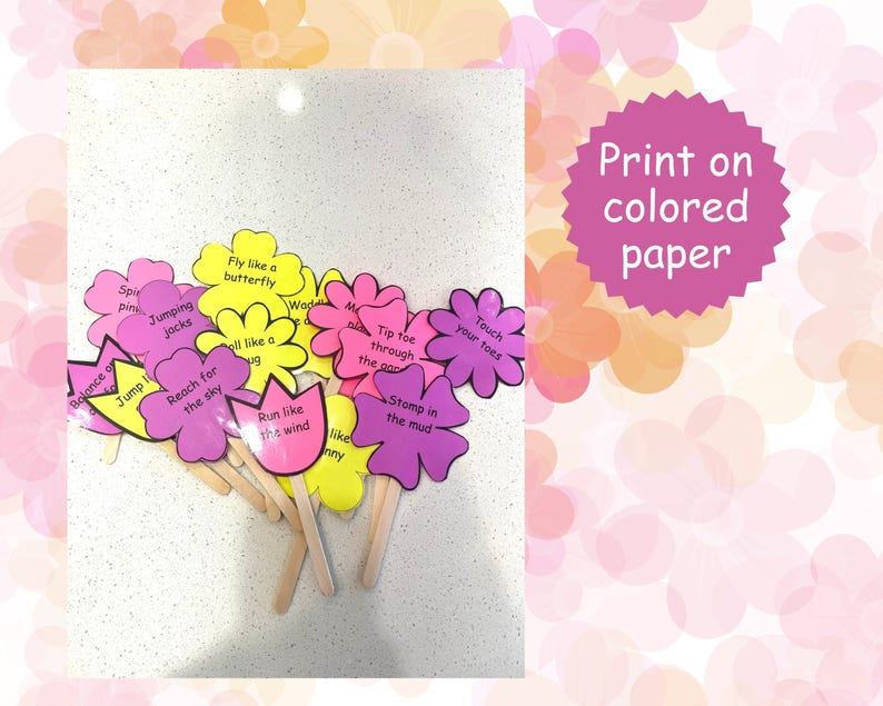 May include: A collection of flower-shaped cutouts in pink, yellow, and purple, each with a wooden stick handle. The cutouts feature phrases like "Jump," "Reach for the sky," and "Fly like a butterfly." A pink circular sign says "Print on colored paper."