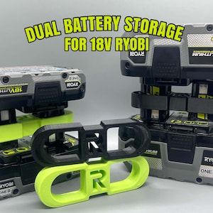 May include: A dual battery storage mount for 18V Ryobi batteries, featuring black and lime green plastic holders. The text DUAL BATTERY STORAGE FOR 18V RYOBI is displayed above the battery units, which are gray and black with yellow labels.