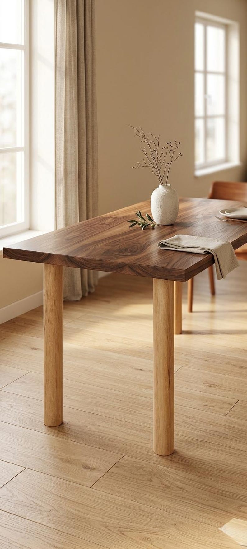 May include: A rectangular wooden dining table with a dark brown top and light brown legs. A white vase with branches and a linen napkin are on the table. The table is 72 inches long.