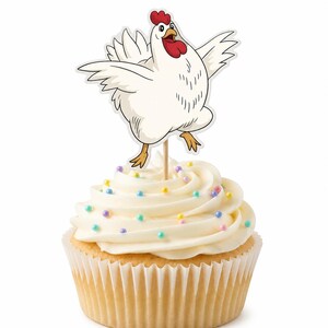 May include: A cupcake topped with white frosting and multicolored sprinkles, featuring a white chicken cake topper with a red comb and wattle, yellow feet, and outstretched wings, attached to a thin wooden pick inserted into the center.
