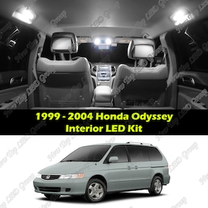 May include: A silver 1999-2004 Honda Odyssey minivan with a black interior. The interior has a white LED light kit installed. The image shows the interior lights on.