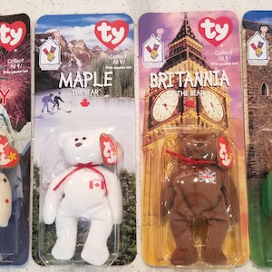 May include: Four Ty Beanie Baby plush toys in their original packaging. The bears are named Glory, Maple, Britannia, and Erin. Glory is cream-colored with red and blue stars and an American flag. Maple is white with a red bow and a Canadian flag.