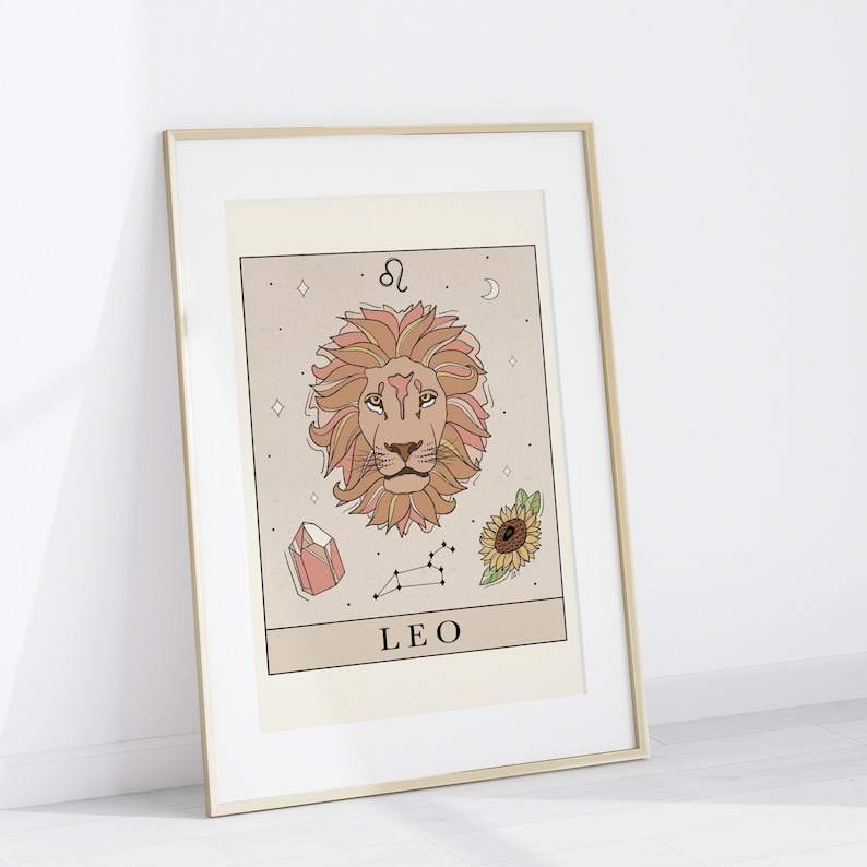 May include: A printable zodiac sign poster featuring a line drawing of a lion's head with a pink and orange color scheme. The poster also includes a constellation, a crystal, a sunflower, and the text "LEO" and the astrological symbol for Leo.