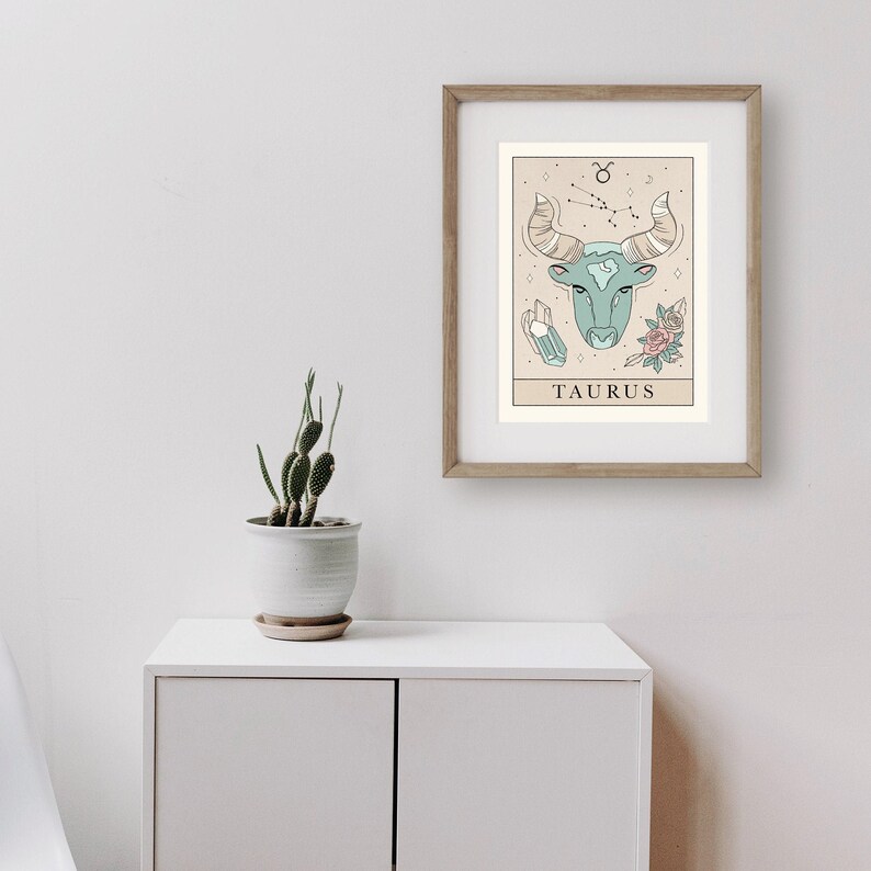 May include: A printable art print featuring a Taurus zodiac sign illustration with a bull head, constellation, crystals, and flowers. The print has a beige background and the text "TAURUS" at the bottom.
