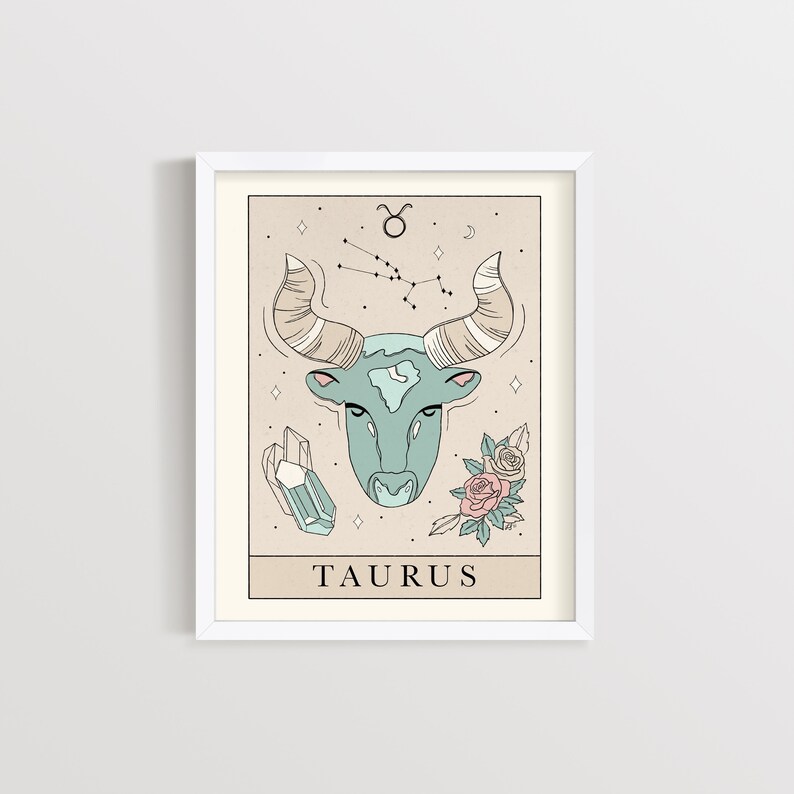 May include: A printable art print featuring a Taurus zodiac sign illustration. The illustration is in a minimalist style with a light blue bull head, pink and white flowers, and a constellation of stars. The text "TAURUS" is printed below the bull head.