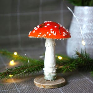Amanita figurine Mushroom on a wood slice and moss Red mushroom sculpture Anthropologie interesting decor Fungi and lichen Woodland Fairy