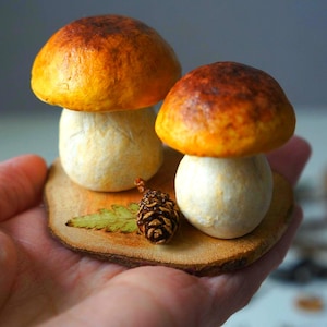 Porcini mushrooms on wood slice Bolete Christmas figure Realistic brown forest mushroom Forest theme natural decoration Mushroom with moss