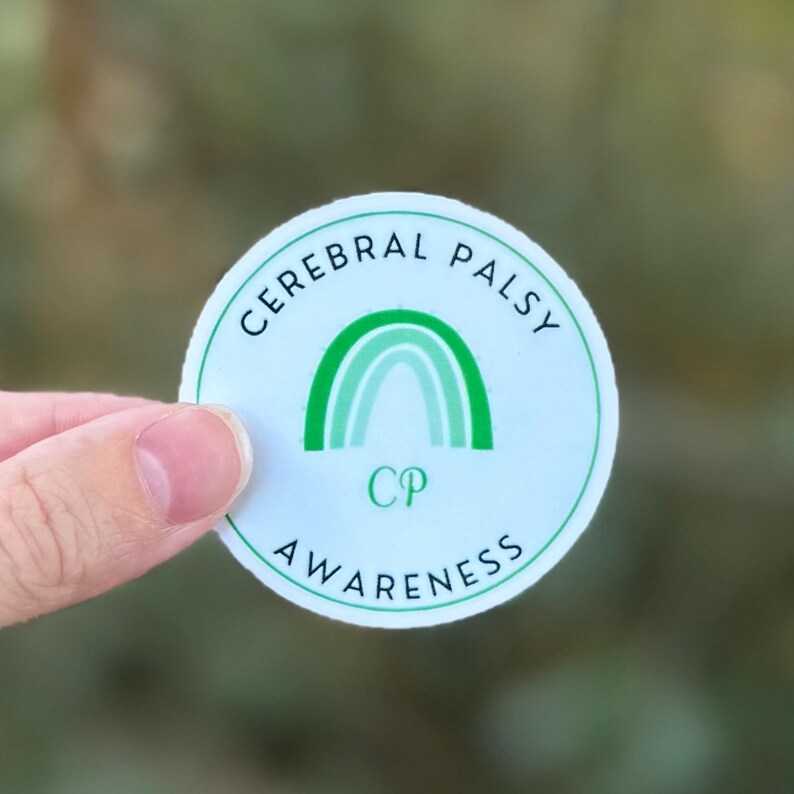 A circular sticker with a light green background featuring a green awareness rainbow in the middle with "CP" underneath. The words "Cerebral Palsy Awareness" wrap around the design.