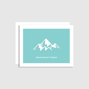 May include: A white mountain silhouette on a light blue background with the text "Mountain of Thanks".