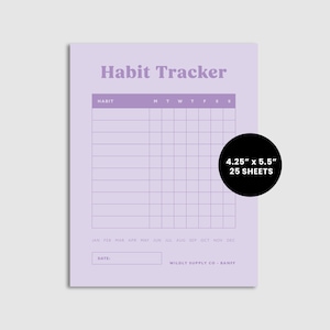 May include: A purple habit tracker notepad with a grid for tracking daily habits. The notepad is 4.25 inches by 5.5 inches and has 25 sheets. The text "Habit Tracker" is at the top of the notepad. The text "M T W T F S S" is at the top of the grid. The text "JAN FEB MAR APR MAY JUN JUL AUG SEP OCT NOV DEC" is at the bottom of the grid. The text "DATE" is below the grid. The text "WILDLY SUPPLY CO. - BANFF" is below the date.