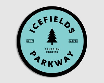May include: A blue and black circular sticker with the text "Icefields Parkway" and "Canadian Rockies" in a white circle. The text "Banff" and "Jasper" are on either side of the circle. A black silhouette of a pine tree is in the center of the circle.