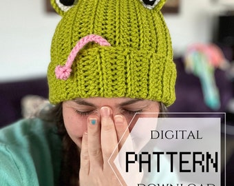 May include: A crochet pattern for a green frog hat with pink tongue and black eyes. The pattern is available for digital download. DIGITAL PATTERN DOWNLOAD.