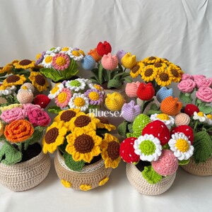 May include: A collection of crocheted flower arrangements in various colors, including yellow, red, pink, white, and orange. Each arrangement is potted in a crocheted basket.