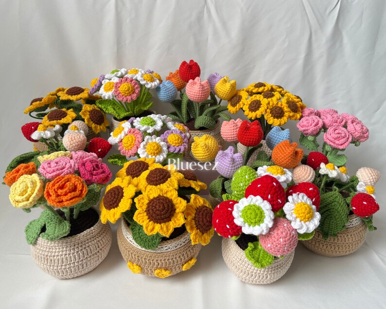 May include: A collection of crocheted flower arrangements in various colors, including yellow, red, pink, white, and orange. Each arrangement is potted in a crocheted basket.