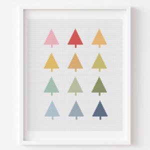 May include: A framed print featuring a grid of twelve colorful Christmas trees. The trees are arranged in three rows of four, each a different pastel color: pink, red, yellow, orange, green, blue, and teal. The background is a light gray dotted pattern.