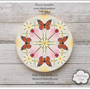 May include: A cross stitch pattern for a flower mandala with butterflies. The pattern features pink, yellow, and green flowers with orange butterflies. The pattern is compatible with Pattern Keeper and is available as a PDF download. The text "Flower mandala cross stitch pattern" is at the top of the image. The text "PDF pattern" is at the left of the image. The text "Compatible with Pattern Keeper" is at the right of the image. The text "With Echinacea flower Monarch butterfly and Coreopsis flower" is at the bottom of the image. The text "Nent Design Crafts" is at the bottom right of the image.