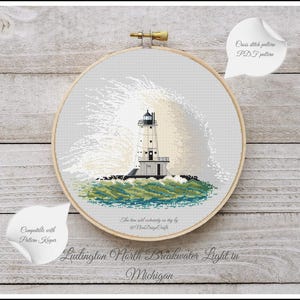 May include: A cross stitch pattern of the Ludington North Breakwater Light in Michigan. The lighthouse is white with a black roof and is surrounded by waves crashing against the rocks. The pattern is available as a PDF download.