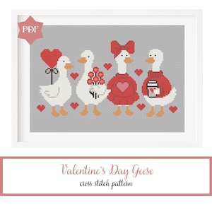 May include: A framed cross-stitch pattern featuring four geese with Valentine's Day themes. The geese are white with orange beaks and feet, wearing red accessories and holding a heart balloon, flowers, and a coffee cup. The text "Valentine's Day Geese" is below.