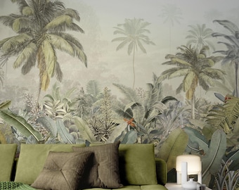 Puede incluir: Un sofá verde con almohadas marrones y una manta de punto verde delante de un mural de papel tapiz de selva tropical.