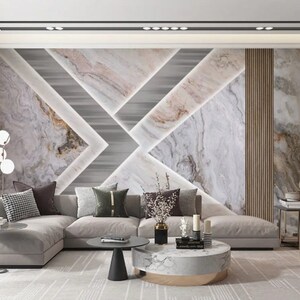 Puede incluir: Un sal&oacute;n moderno con un sof&aacute; seccional, una mesa de caf&eacute; y una pared decorativa con un patr&oacute;n geom&eacute;trico de m&aacute;rmol blanco y gris. La pared presenta un fondo gris claro con un patr&oacute;n de m&aacute;rmol blanco y gris.