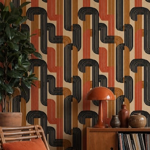 May include: Retro-style wallpaper with a repeating pattern of black, rust, and brown curved lines on a beige background. The image also includes a wooden cabinet, a lamp, and decorative items.