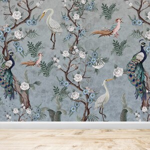 May include: A blue and gray wallpaper with a floral pattern featuring white flowers, blue flowers, and green leaves. Peacocks and white birds are perched on the branches of the trees.