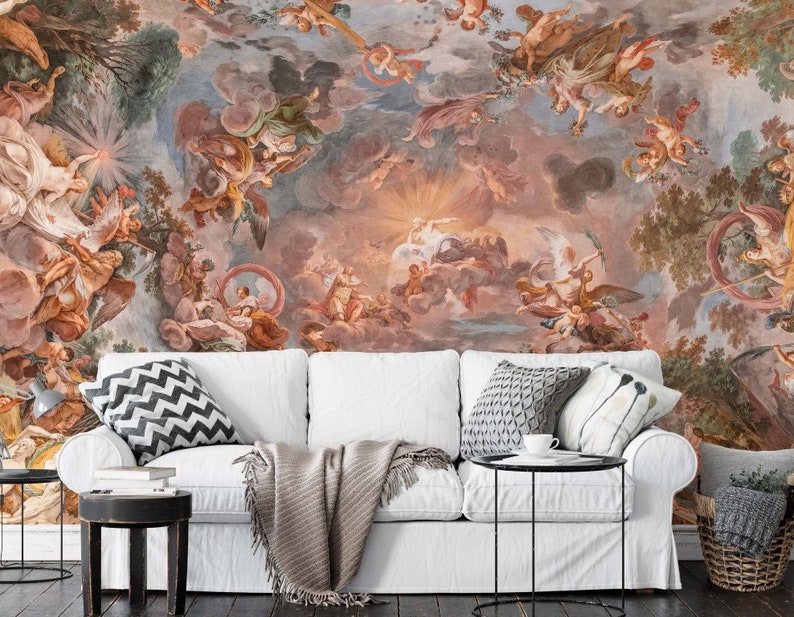 May include: A white couch with a throw blanket and pillows in front of a mural depicting a colorful, ornate ceiling with angels and cherubs.