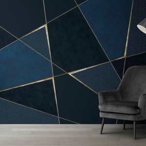 May include: A dark blue and gold geometric patterned wall with a black armchair and a floor lamp in the corner.