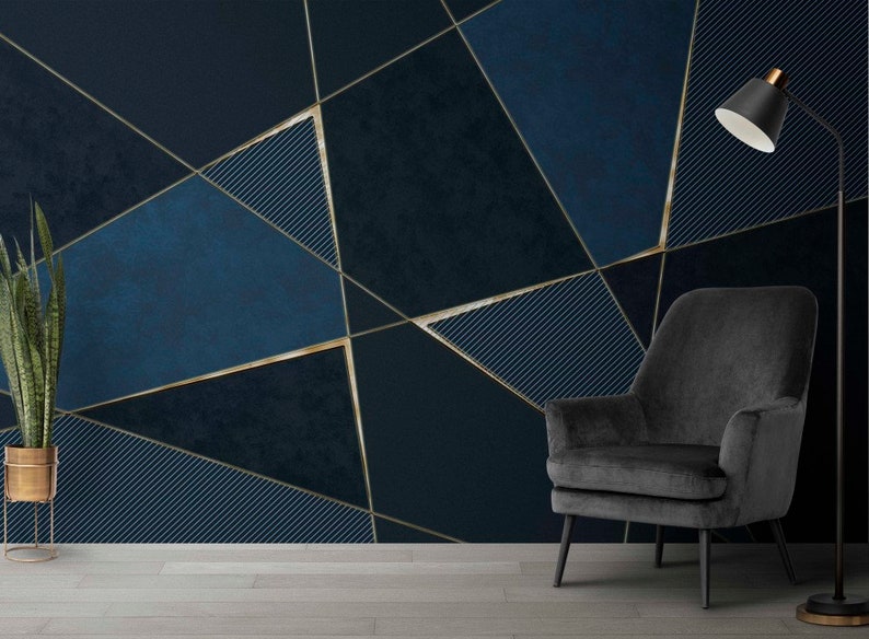 May include: A dark blue and gold geometric patterned wall with a black armchair and a floor lamp in the corner.