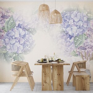 May include: A dining room with a light beige wall featuring a watercolour mural of purple hydrangeas. The room has a wooden table with four chairs and a bench. Two woven pendant lights hang above the table.