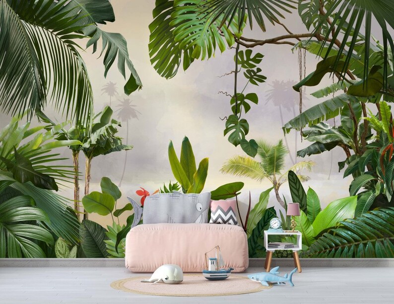 May include: A pink upholstered bed with a tropical jungle mural wallpaper featuring lush green palm trees and leaves. The bed has a white and gray patterned pillow and a pink and gray patterned pillow. A small wooden side table with a lamp and a clock sits next to the bed.