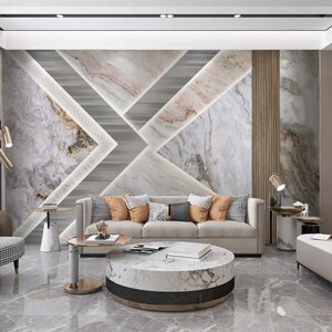 Puede incluir: Un interior de sala de estar moderno con un sof&aacute; blanco y una mesa de caf&eacute; de m&aacute;rmol. La pared presenta un patr&oacute;n geom&eacute;trico de azulejos de m&aacute;rmol blanco y gris con un acento marr&oacute;n claro.
