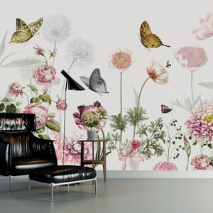 May include: A black leather armchair with a matching ottoman sits in front of a wall mural featuring a floral design with butterflies. The mural features pink, white, and green flowers with brown butterflies.