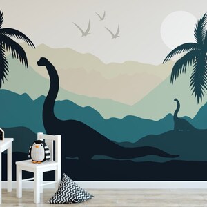Puede incluir: Un paisaje de monta&ntilde;a azul verdoso y beige con dos palmeras y dos dinosaurios. Los dinosaurios son siluetas negras. Tambi&eacute;n hay p&aacute;jaros blancos volando en el cielo.