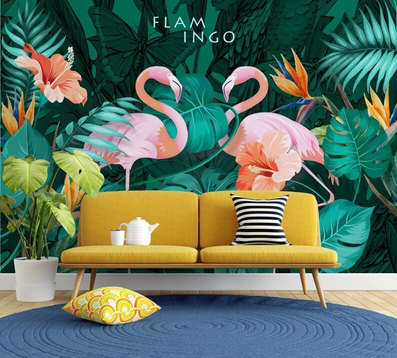 May include: A yellow couch with a striped pillow sits in front of a tropical mural featuring pink flamingos, green leaves, and orange flowers. The mural has the text "FLAMINGO" at the top.