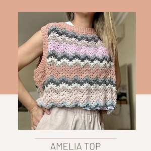 Pode incluir: Um padrão de crochê para um top chamado "Amelia Top" desenhado por Laramiloops. O padrão apresenta um design chevron colorido em tons de rosa, cinza e azul.
