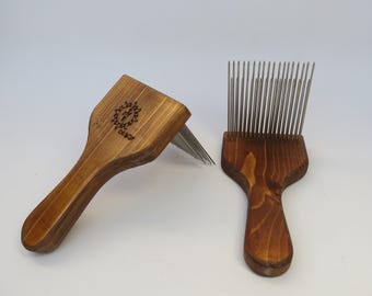 May include: Two wooden handled wool combs with metal teeth. The combs are made of natural wood and have a dark brown stain. The combs are used for carding wool.