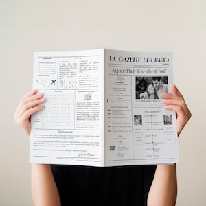 May include: A black and white newspaper-style wedding announcement with the headline "La Gazette des Maries" and the text "Aujourd'hui, ils se disent "oui"". The announcement features a photo of the couple and a timeline of their relationship.