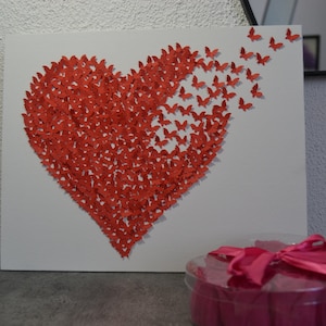 Painting with a heart formed with paper butterflies