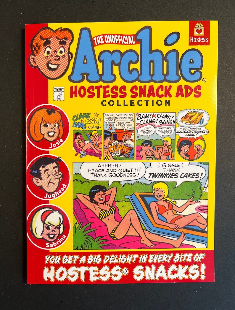 May include: A yellow and red comic book cover featuring the Archie characters. The cover features the text "The Unofficial Archie Hostess Snack Ads Collection". The characters are depicted in various scenes with Hostess snack products. The text "You get a big delight in every bite of Hostess Snacks!" is at the bottom of the cover.