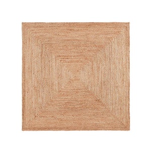 May include: A natural fiber rug with a square shape and a woven pattern. The rug has a light brown color and a subtle texture.